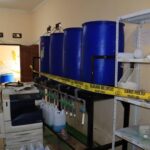Raid on Silk Screen Printing Facility Leads to Shocking Discovery: Police Bust Counterfeit Detergent Ring, Seize Hundreds of Plastic Cans Filled with Chemicals and Industrial Mixing Machines