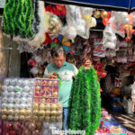 Christmas Decorations at Rock-Bottom Prices: Staff Brave the Heat to Attract Customers, Yet Sales Remain Slow